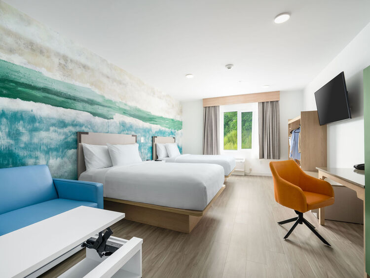 Double Queen room with two queen beds, a work desk, and kitchen
