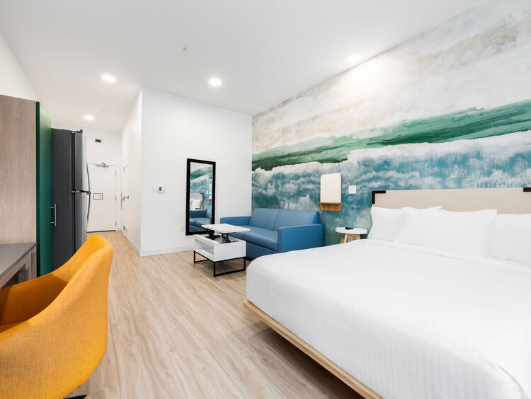 Standard Queen room with one queen bed and a sofa