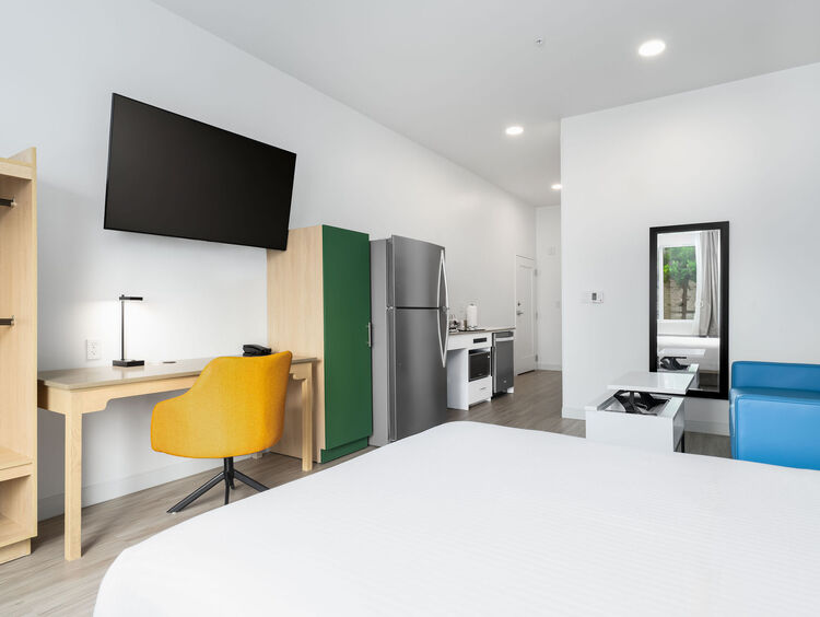 Standard Queen ADA room with a queen bed, sofa and in-suite laundry