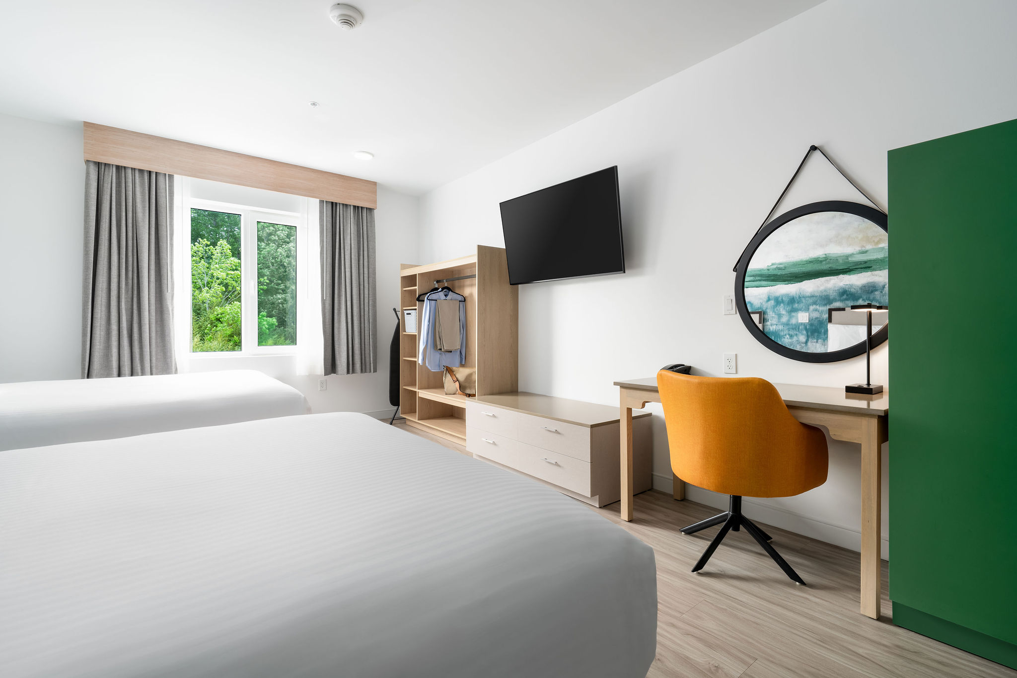 Double Queen room with large streaming tv, work space, in-suite laundry and full kitchen