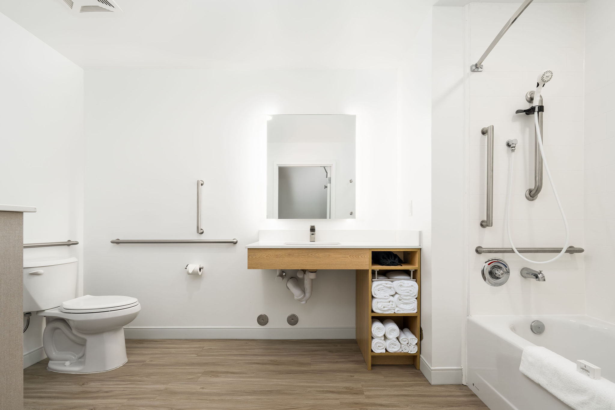 ADA Bathroom with a toilet, sink, and mirror