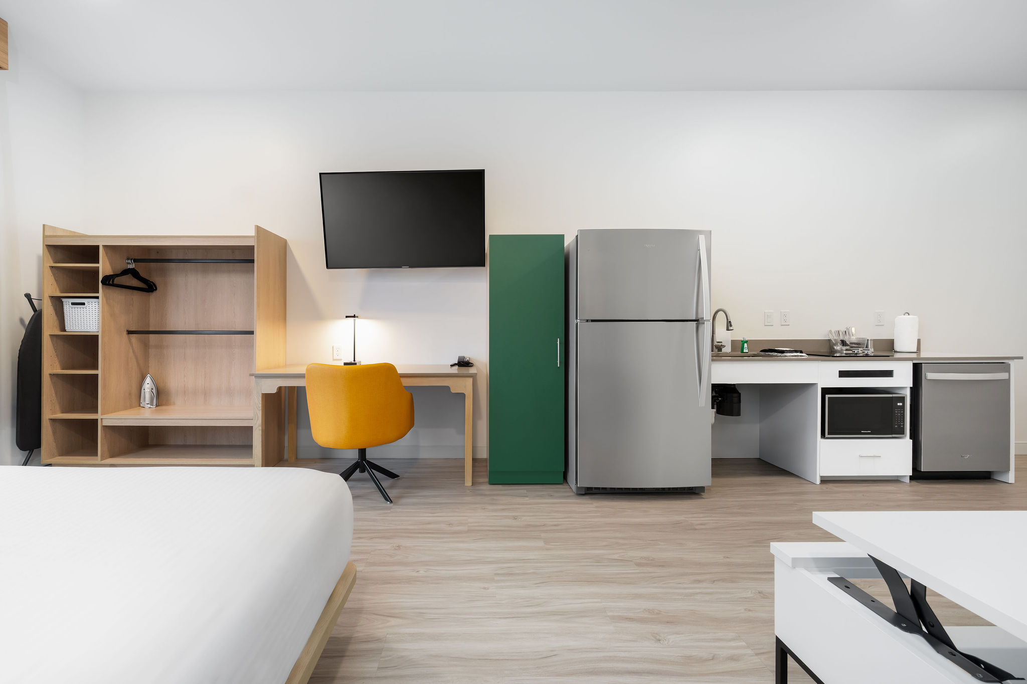 Standard Queen ADA room with one queen bed, work desk, and kitchen