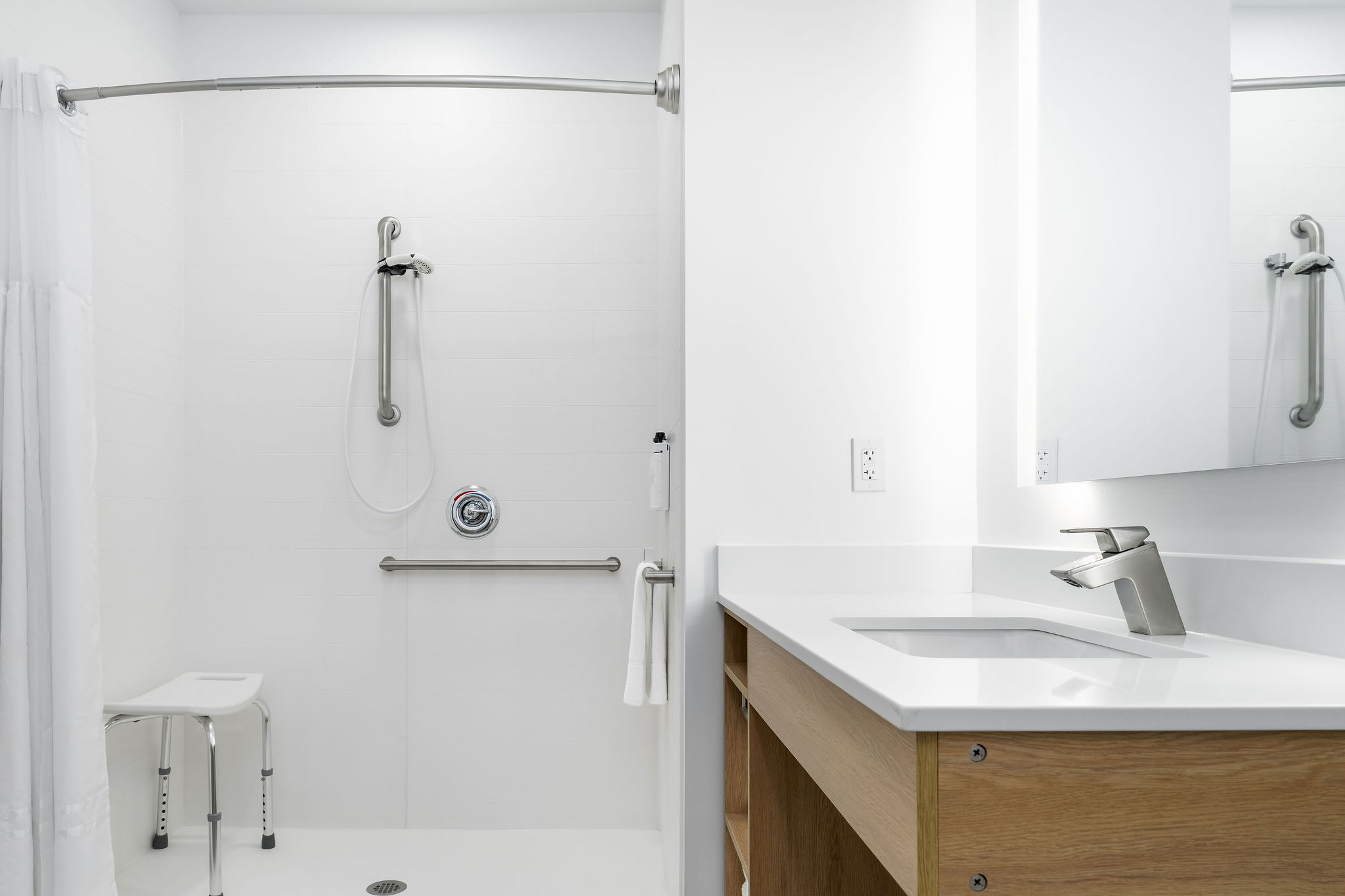 ADA Bathroom with a shower, sink, and laundry machines